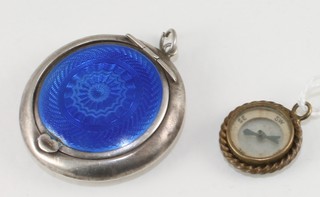 A gilt metal watch chain medallion in the form of a compass and  a silver and blue enamelled compact