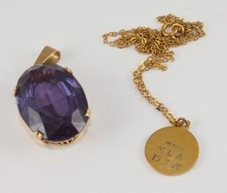 A 9ct gold St Christopher hung on a gold chain together with an  amethyst pendant