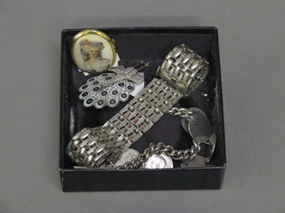 A silver curb link bracelet hung coins and 2 brooches