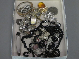 A collection of costume jewellery including a silver napkin ring  and a marcasite wristwatch