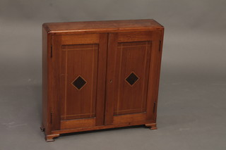 An inlaid cedar table top cigar cabinet enclosed by panelled doors, raised on ogee bracket feet 21"