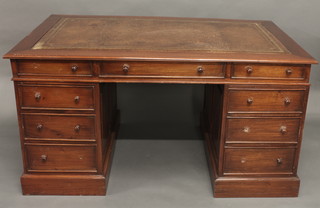 A Georgian style mahogany kneehole pedestal desk with inset tooled brown leather writing surface, fitted 1 long and 8 short  drawers 59"