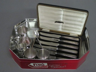 A set of 6 silver handled tea knives and 6 various egg cups