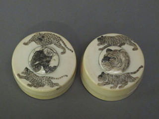 A pair of carved ivory jars decorated elephants and lions 2 1/2"