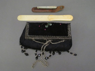 A silver bladed fruit knife with mother of pearl grip, an ivory letter opener and a lady's evening bag