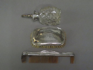 A silver backed military hair brush and comb, together with a cut glass perfume atomiser with silver collar