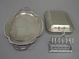 An oval silver plated twin handled tea tray, an entree dish and cover and a 7 bar toast rack