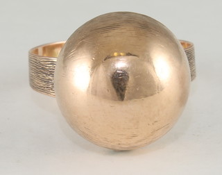A lady's 14k gold ress ring decorated a "gold" sphere