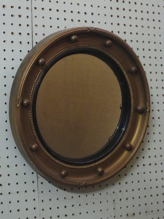 A circular convex plate wall mirror contained in a gilt ball  studded frame 14"