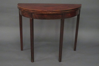 A Georgian mahogany demi-lune tea table, raised on square supports 36"