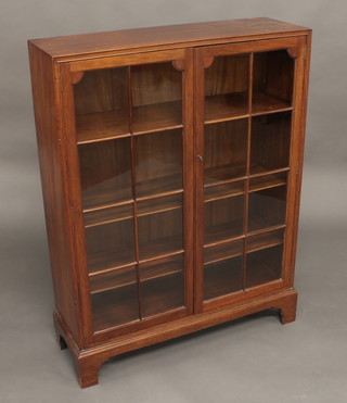 A 19th Century mahogany bookcase, fitted adjustable shelves enclosed by astragal glazed panelled doors and raised on bracket  feet 32"