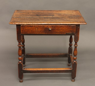 An 18th Century oak side table fitted a frieze drawer and raised  on turned and block supports 30"
