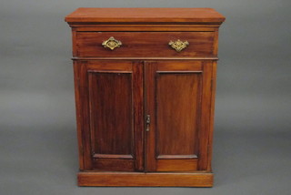 An Edwardian walnut side cabinet fitted a drawer above a double cupboard, raised on a platform base 28"