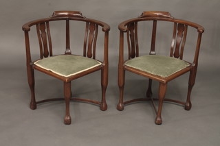 A pair of Edwardian Art Nouveau mahogany corner chairs with  slat backs and X framed stretchers