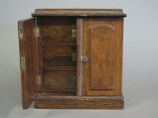 A Victorian walnut table top cabinet, the interior fitted 3 long drawers with brass counter sunk handles, enclosed by panelled  doors and raised on a platform base 11 1/2"