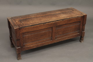 An oak coffer of panelled construction with hinged lid 42"