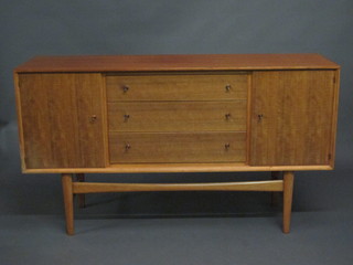A Gordon Russell teak sideboard fitted 3 long drawers flanked by  a pair of cupboards, raised on tapered supports 60"