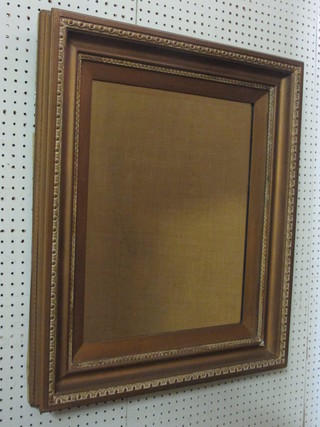 A rectangular bevelled plate wall mirror contained in a decorative  gilt frame 29"