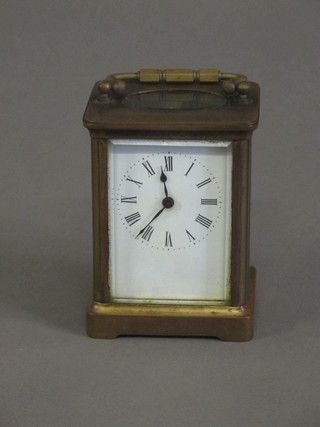A 19th Century French 8 day carriage clock with enamelled dial  and Arabic numerals contained in a gilt metal case