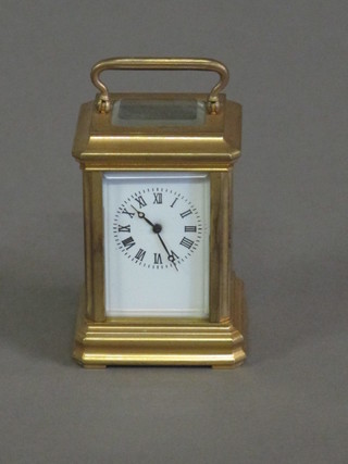 A reproduction French 8 day carriage clock with enamelled dial  and Roman numerals contained in a gilt metal case 1"