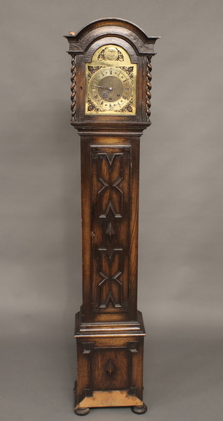 A 1920's chiming Granddaughter clock with 7 1/2" brassed dial with sliding hood, contained in an oak case 64"