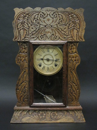 An American striking shelf clock with painted dial contained in a carved oak case 15"