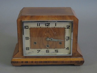 An Art Deco 8 day striking mantel clock with square silvered dial  and Arabic numerals contained in a walnut case