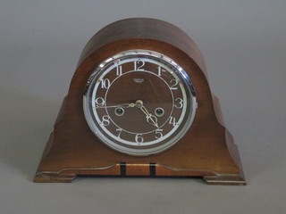 An Art Deco Smiths 8 day striking mantel clock with Arabic  numerals contained in a walnut arch shaped case