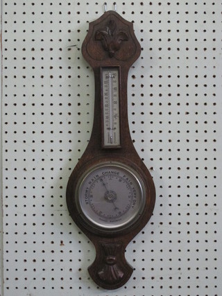 An aneroid barometer and thermometer with silvered dial  contained in a wheel case
