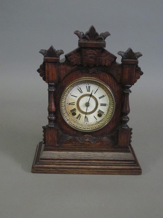 A striking mantel clock contained in a walnut case by Ansonia