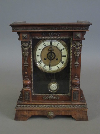 A Continental striking mantel clock with paper dial and Roman  numerals contained in a walnut case