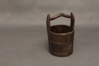 An Oriental style wooden bucket with handle