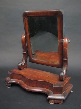 A Victorian arch shaped dressing table mirror contained in a  mahogany swing frame