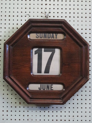 A wall mounting perpetual calendar contained in a mahogany finished case 15"