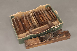 A large wooden jack plane and 14 moulding planes