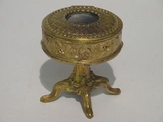 A circular Continental gilt metal trinket box the lid decorated a portrait of a lady, raised on a tripod base, marked Depose 5"