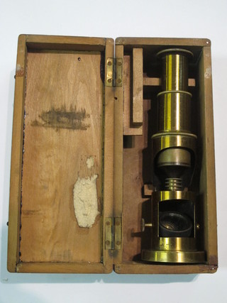 A student's brass single pillar microscope together with a set of scales