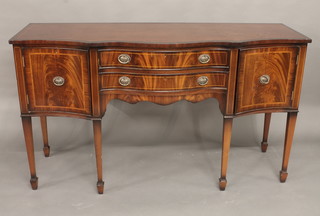 A Georgian style mahogany sideboard of serpentine outline fitted  2 long drawers flanked by a double cupboard, raised on square  tapering supports ending in spade feet 63"