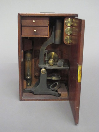 A student's brass single pillar microscope and a collection of  various slides contained in a mahogany box
