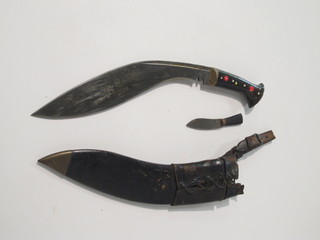 A Kukri, the 30" blade marked M43 complete with leather  scabbard, missing 1 skinning knife, the grip marked S Leon RAE