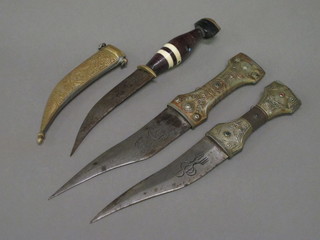 An Eastern dagger with 5 1/2" blade complete with brass  scabbard and 2 other Eastern daggers with 6" blades