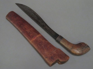 An Oriental knife, the 11" blade with seal mark, the handle  carved a lotus leaf contained in a hardwood scabbard