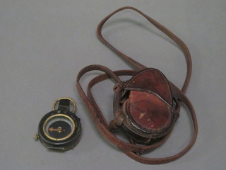 A Military prismatic compass marked F-L128761 1918 complete  with leather case