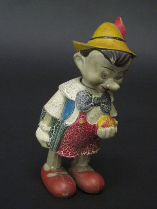 A 1930's clockwork figure of a walking Pinocchio