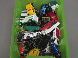 A collection of Matchbox and Lesney cars in a green crate