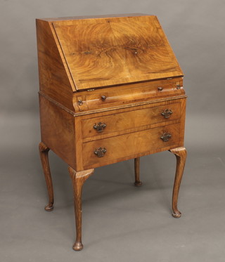 A Queen Anne style walnut bureau with fall front above 3 long drawers, raised on cabriole supports 23"