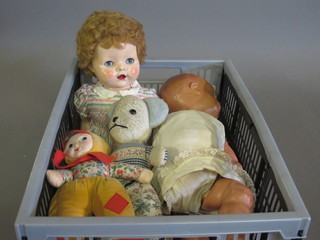 A crate containing a collection of dolls