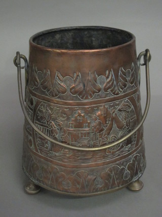 A cylindrical Dutch style embossed peat/coal bucket raised on  brass bun feet 10"