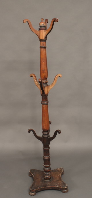 A Victorian turned mahogany hat and coat stand on a triform  base