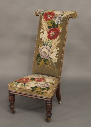 A William IV rosewood Prie Dieu chair, the seat and back upholstered in floral Berlin wool work, raised on turned and  reeded supports